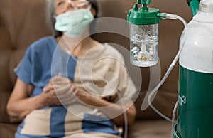 Elderly woman wearing oxygen nasal canula at home photo