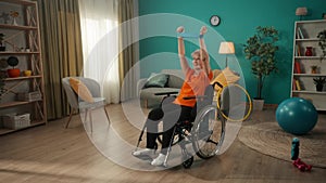 An elderly woman in a wheelchair is exercising with a sports elastic band in the living room. An elderly grayhaired