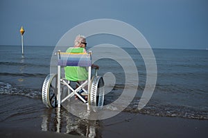 Elderly woman in a wheelchair in the sea