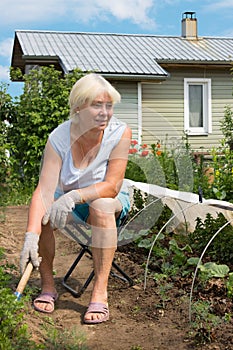 Elderly woman working in the garden