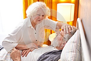 elderly woman is worried about health condition of sick husband