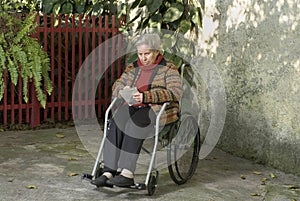 Elderly Woman Writing in Wheelchair - Horizontal