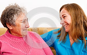 Elderly woman and young caregiver