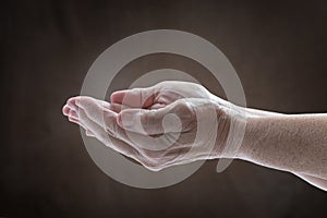 An Elderly Womanâ€™s Cupped Hands Expressing Need