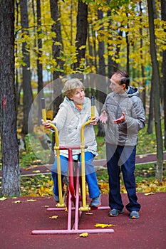 Elderly women is engaged on sport simulator and photo