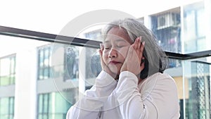 Elderly women keep their facial skin fresh while sitting at home.