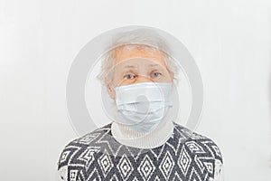 Elderly women retirement age in a medical mask. Quarantine concept