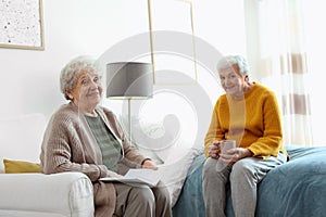 Elderly women spending time in bedroom. Senior people care