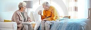 Elderly women spending time together in bedroom. Senior people care