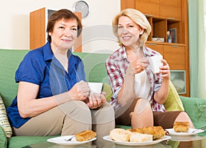 Elderly women at the table with tea