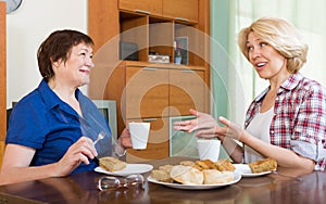 Elderly women at the table with tea