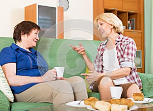 Elderly women at the table with tea