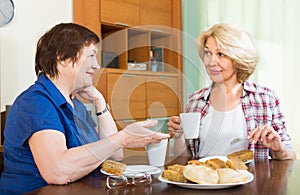Elderly women at the table with tea