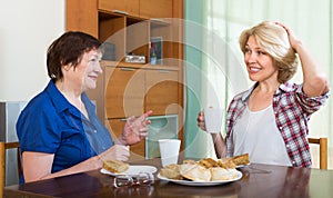 Elderly women at the table with tea