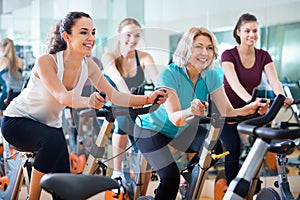 Elderly and young women working out hard