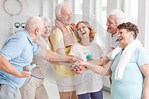 Elders laughing before yoga classes