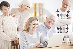 Elders smiling at laptop photo