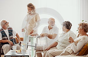 Elders spending time in the common room of the care home photo