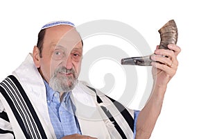 Eldery jewish man blowing the Shofar horn for Rosh Hashanah