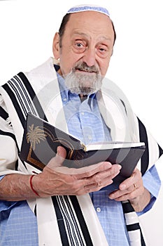 Eldery jewish man wrapped in talit praying