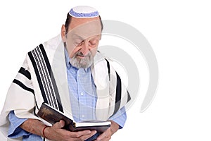 Eldery jewish man wrapped in talit praying photo