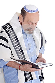 Eldery jewish man wrapped in talit praying photo