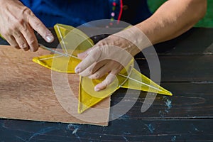 Eldery woman making and build star-shaped kite or thai name Chula kite for sale at local market.