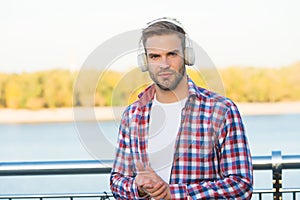 Elearning concept. quality of sound. innovative wireless device. unshaven guy with ear stereo headphones. male casual