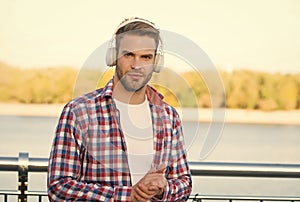 elearning concept. quality of sound. innovative wireless device. unshaven guy with ear stereo headphones. male casual