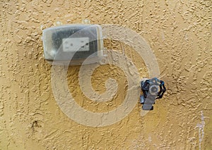 Elecetric Outlet Covered with a Metal Water Spigot