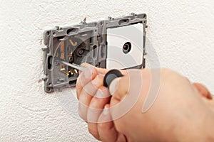 Electician hands installing electical wall sockets