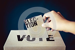 Election card insert in vote box, democracy concept