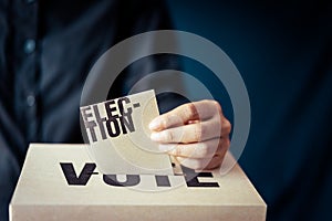 Election card insert in vote box, democracy concept