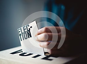 Election card insert in vote box, democracy concept