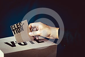 Election card insert in vote box, democracy concept
