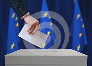 Election in EU. Voter holds envelope in hand above vote ballot.