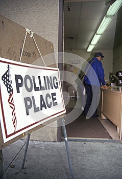 Election volunteers assisting voters in a polling place, CA