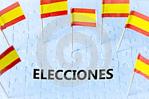 Elections in Spain, The concept of the Spanish flag and the text ELECCIONES meaning vote in English on white puzzles photo