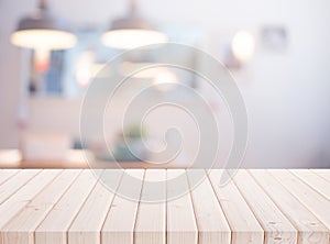 elective focus.Wood table top on blur living room or kitchen background photo
