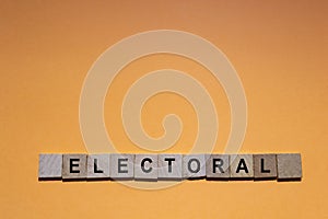 ELECTORAL. Word written on square wooden tiles with an orange background.