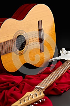 Electric and acoustic guitars on red cloth