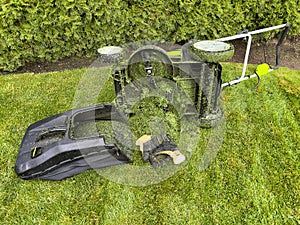 Electric battery lawn mower having difficulty cutting wet grass