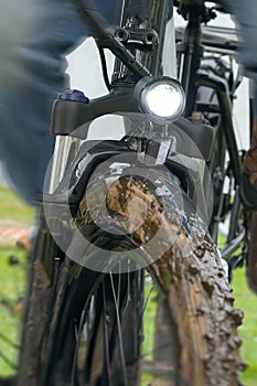 Electric bike plowing through a mudyy field on a rainy day