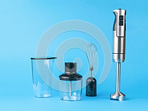 Electric blender with nozzles on a blue background