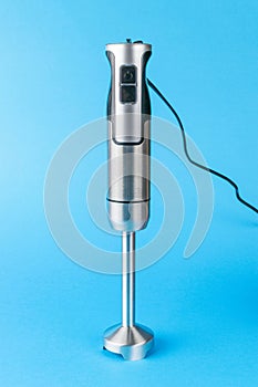 Electric blender with a wire on a blue background