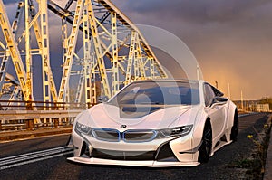 Electric BMW i8 Roadster on the old bridge during an evening storm