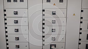 Electric board and system control stand in industrial plant with different switches and buttons.