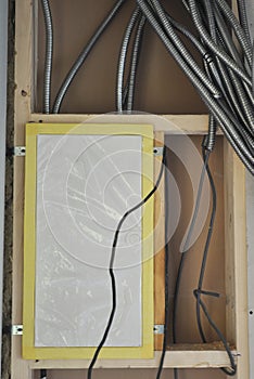 Electric Box installation in frame house wall with metal wire coverings for cable and wire protection