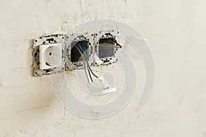 Electric box with socket and switch. Installing electricity connector in plastered wall. Construction of house and home renovation