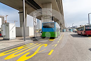 Electric bus at a stop is charged by pantograph. Clean mobility